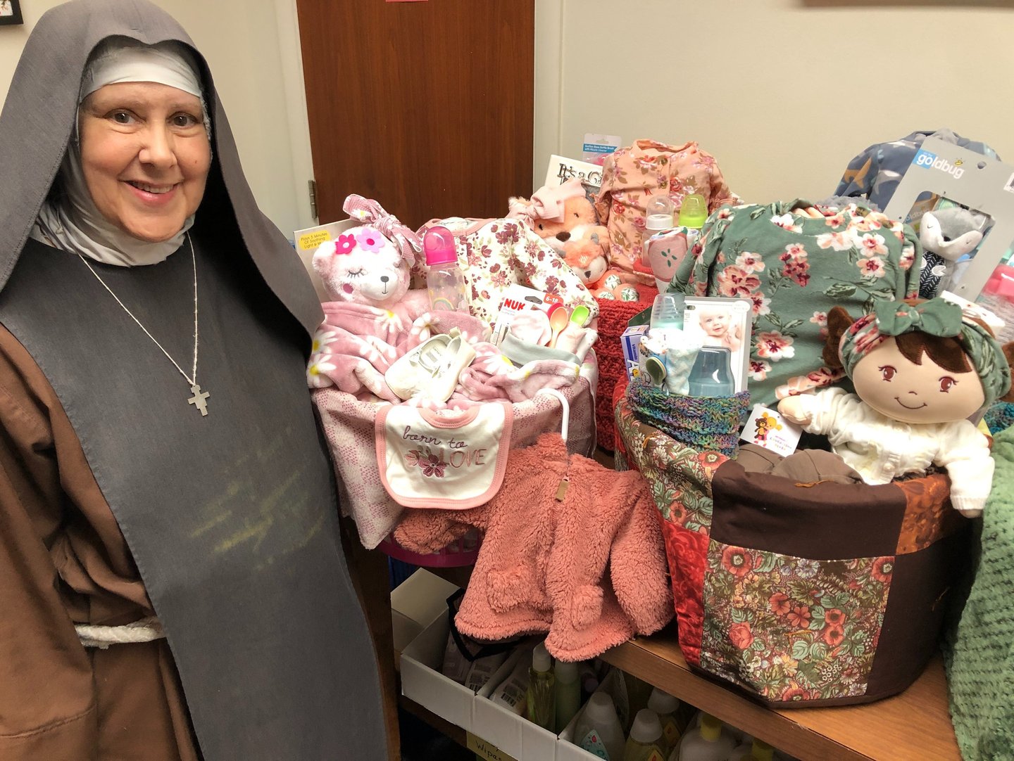 A fransican Daughter of Mary making baby baskets at the Rose Garden Mission