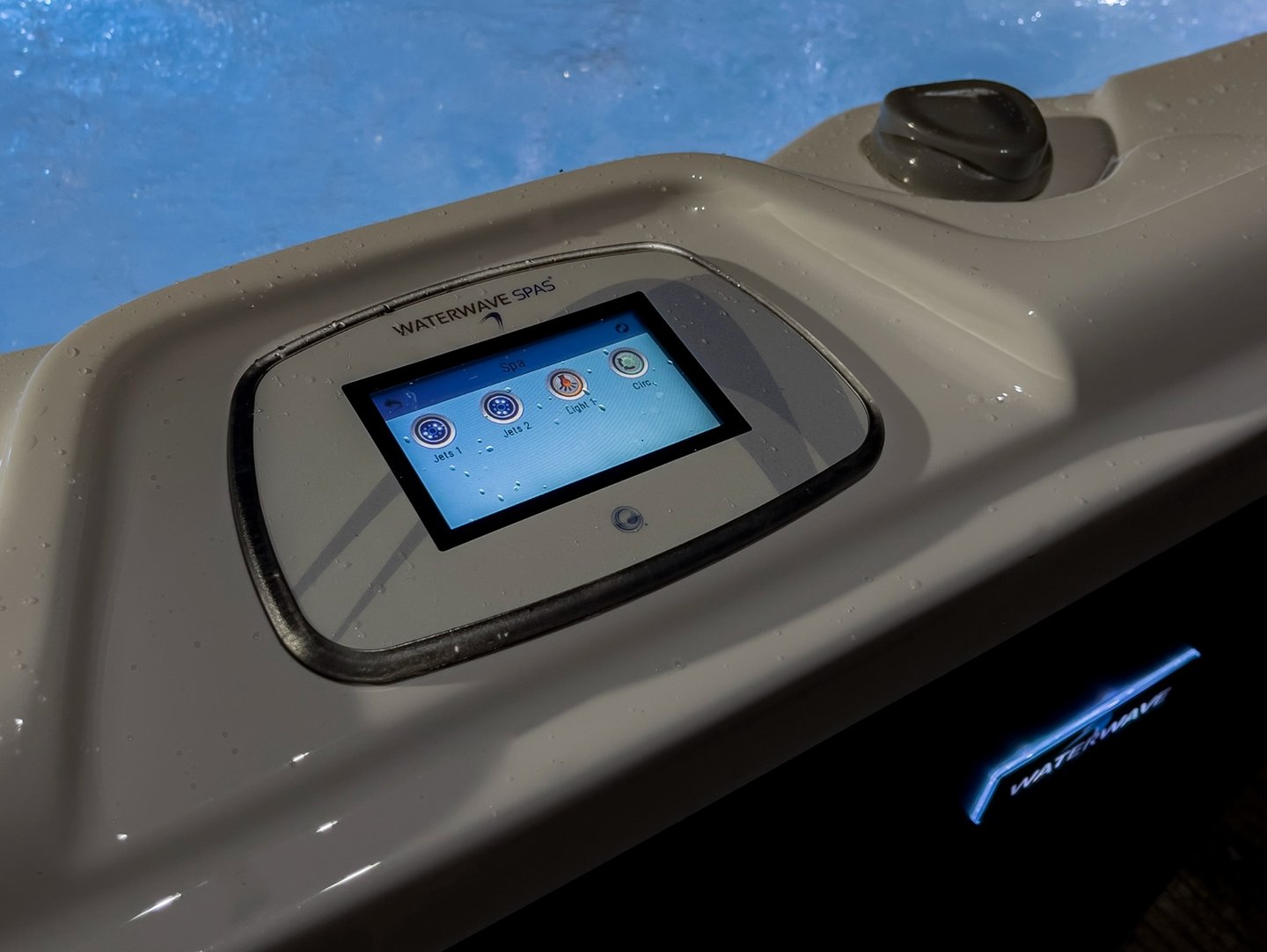 a hot tub with a large white tub and a black background