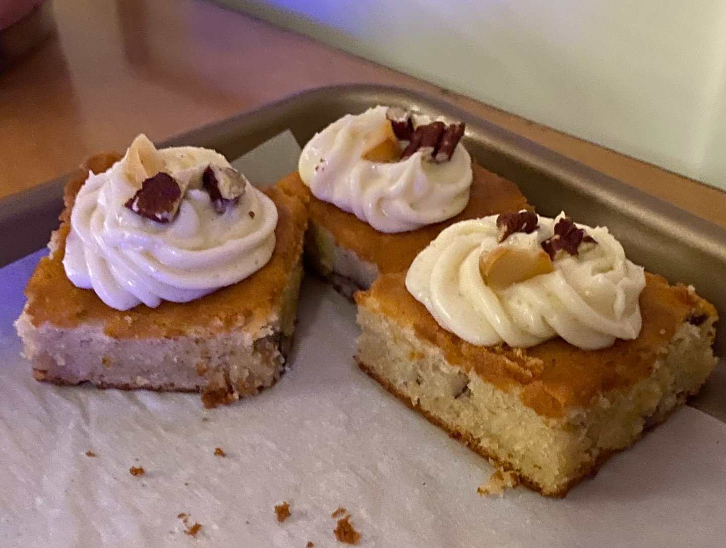 3 frosted cake bars on a sheet pan