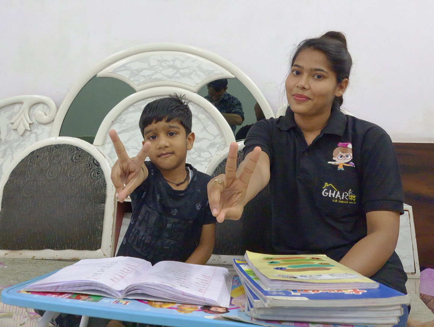 a woman sitting at a table with a child