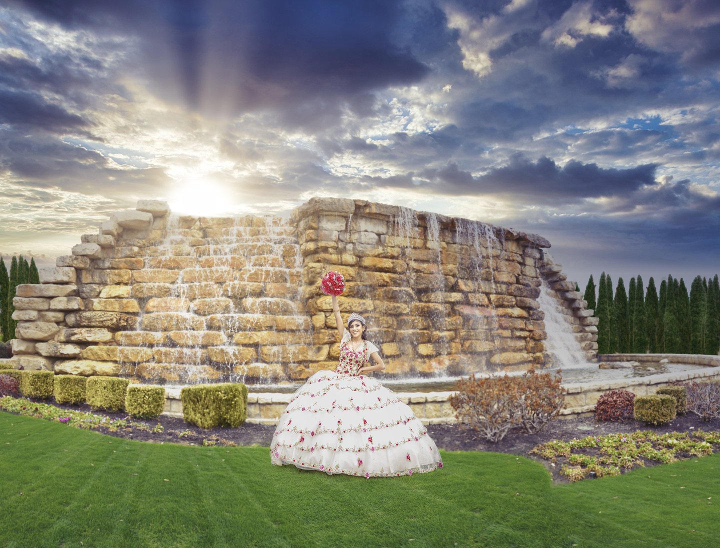 a woman in a white quinceanera dress standing in front of a fountain
