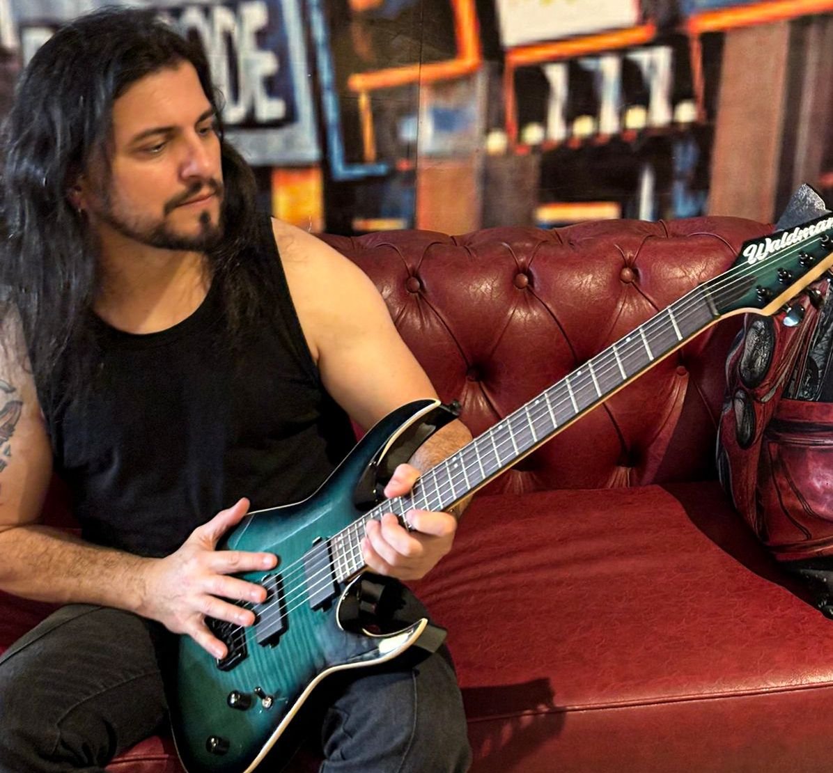 a man with long hair and a guitar