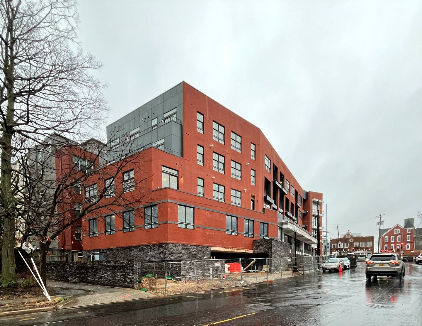 A photograph of a red brick apartment building