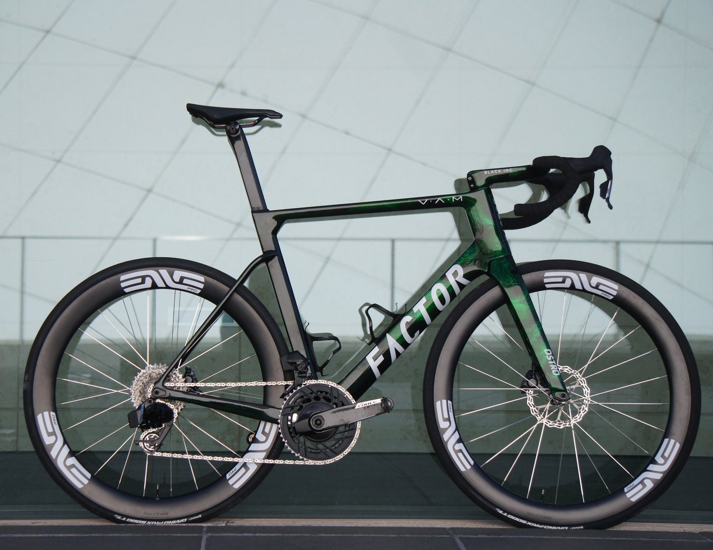 A Factor OSTRO VAM aero road bike with green camouflage paint and ENVE carbon wheels.
