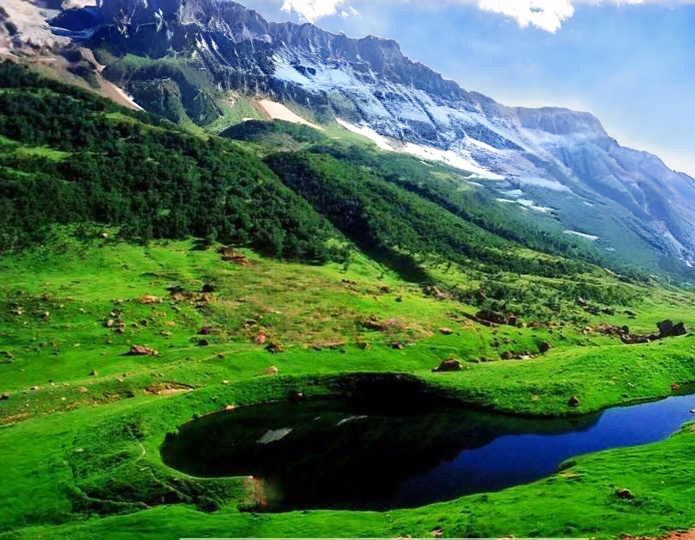 a mountain scene with Ansoo Lake and a mountain in the background