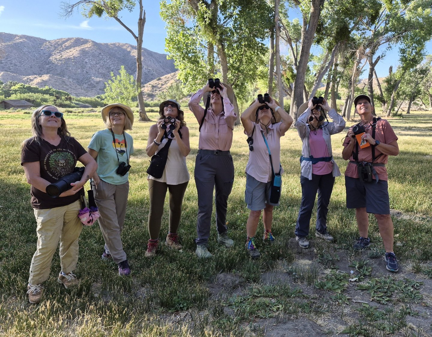 women birders with binoculars in big morongo canyon preserve near joshua tree
