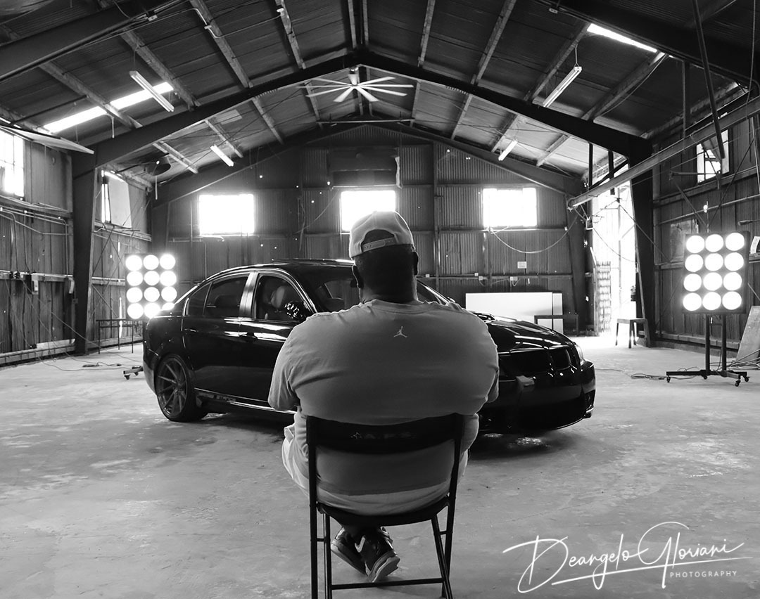 a man sitting in a chair in a garage