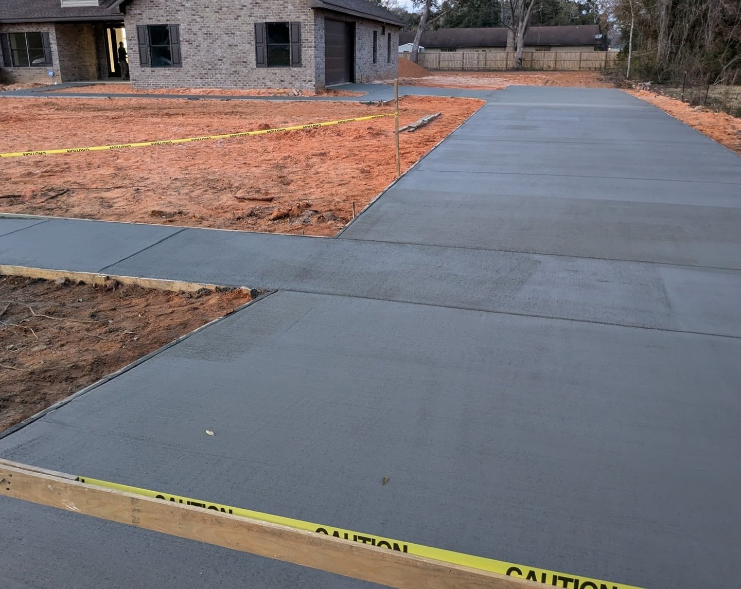Newly poured concrete driveway in Pensacola FL showing fresh installation and leveling