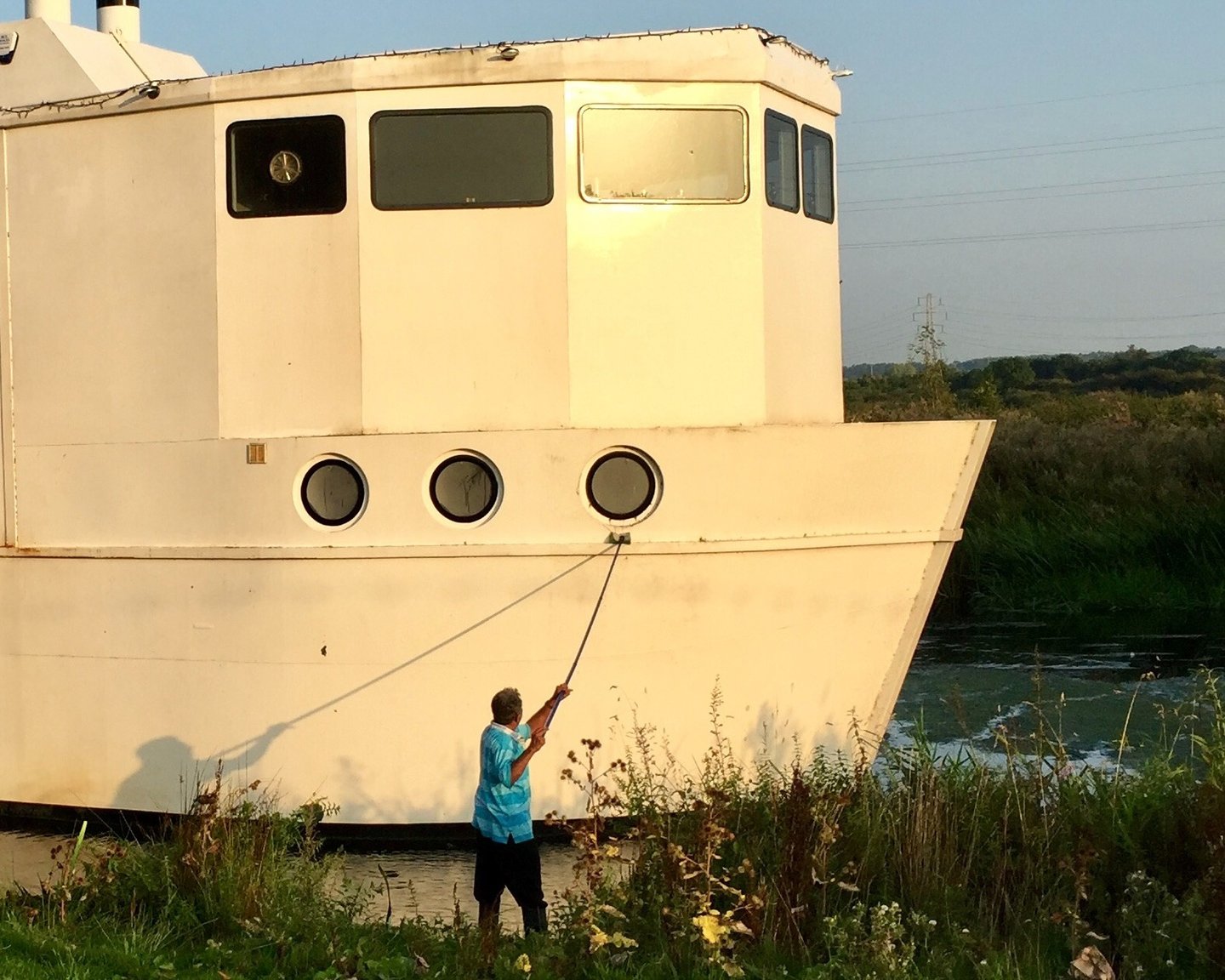 Jack patel is cleaning the ark northampton while standing in the river nene