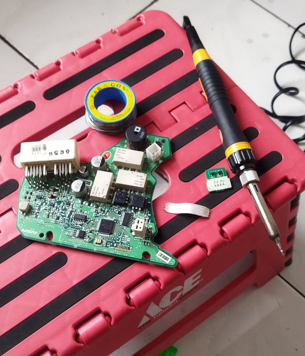 a pink box with a computer mouse and a pair of scissors