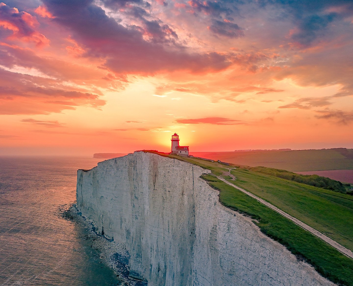 photograph of Belle Tout Lighthouse at the top of the chalk cliffs of Beachy Head at sunset