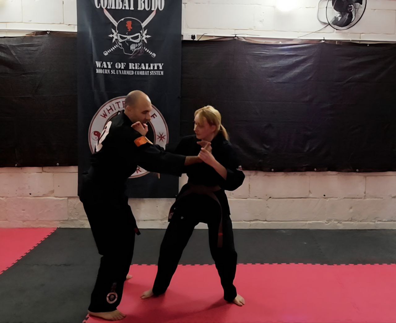 a man and woman doing a karate pose