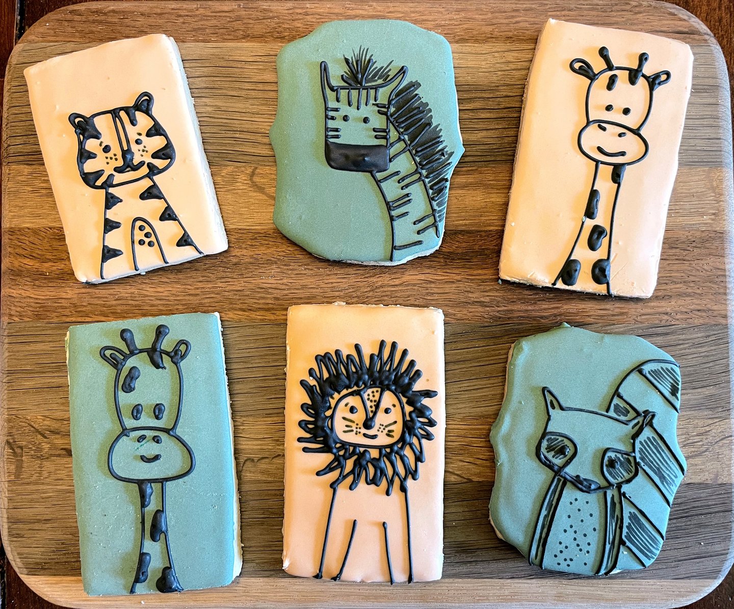 Simply adorable cookies for a kid's birthday party. Cartoon animals on light backgrounds