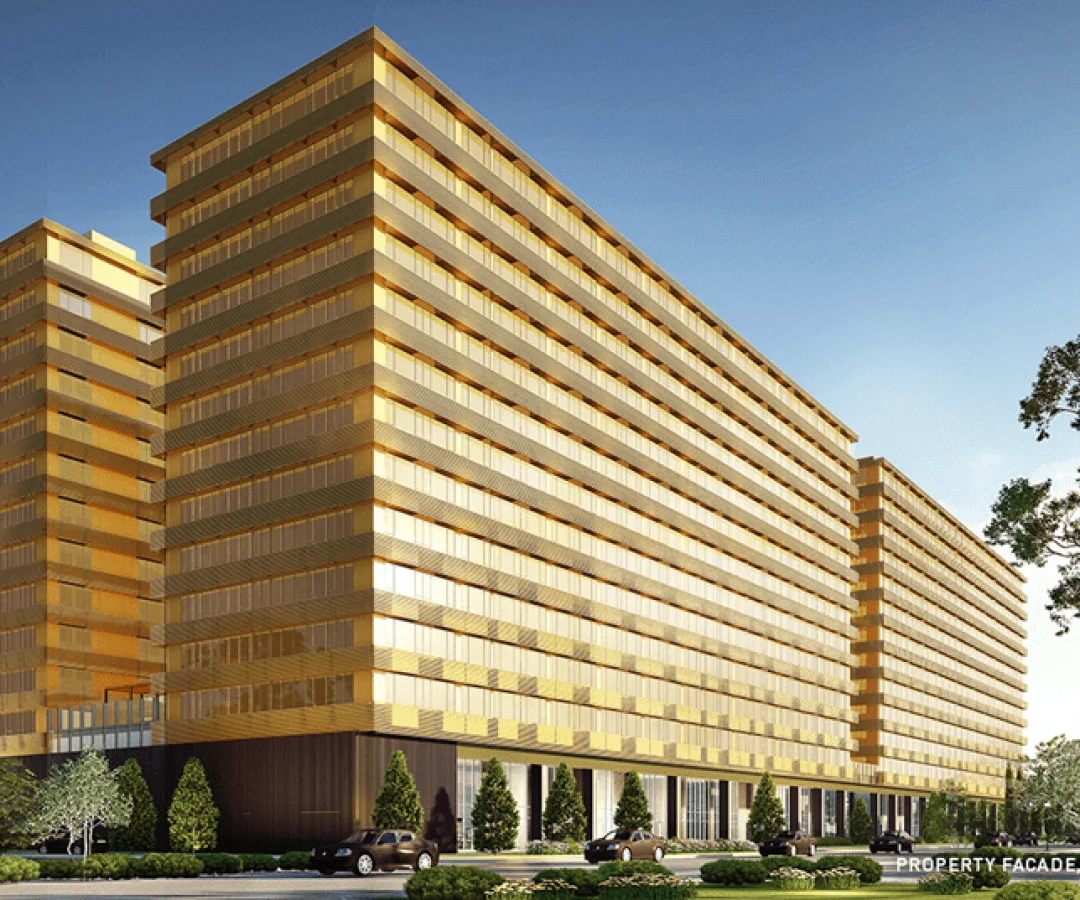 Modern luxury high-rise apartment complex with gold-tinted glass facade and urban landscaping.