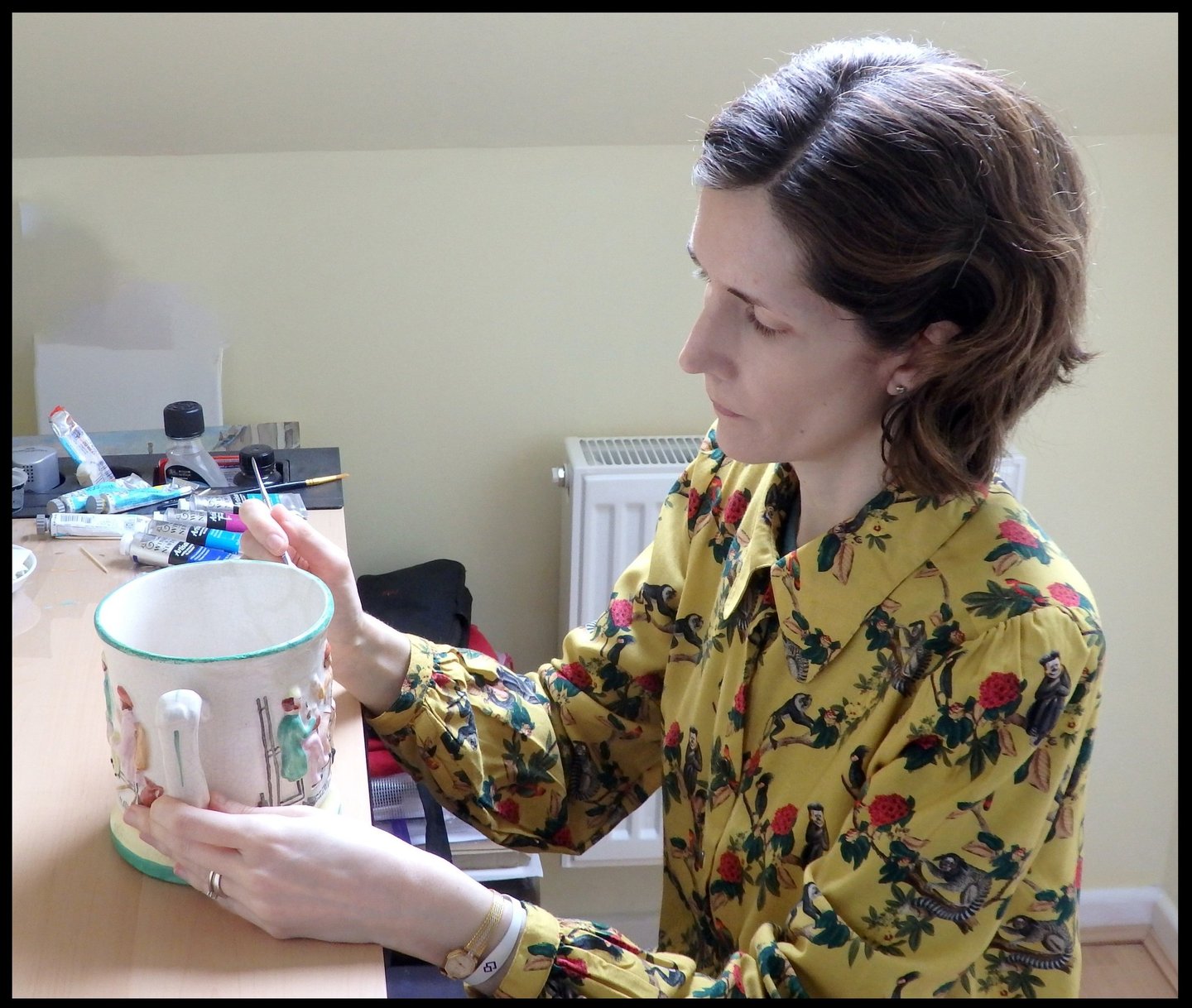 Mandy conserving a ceramic frog surprise mug