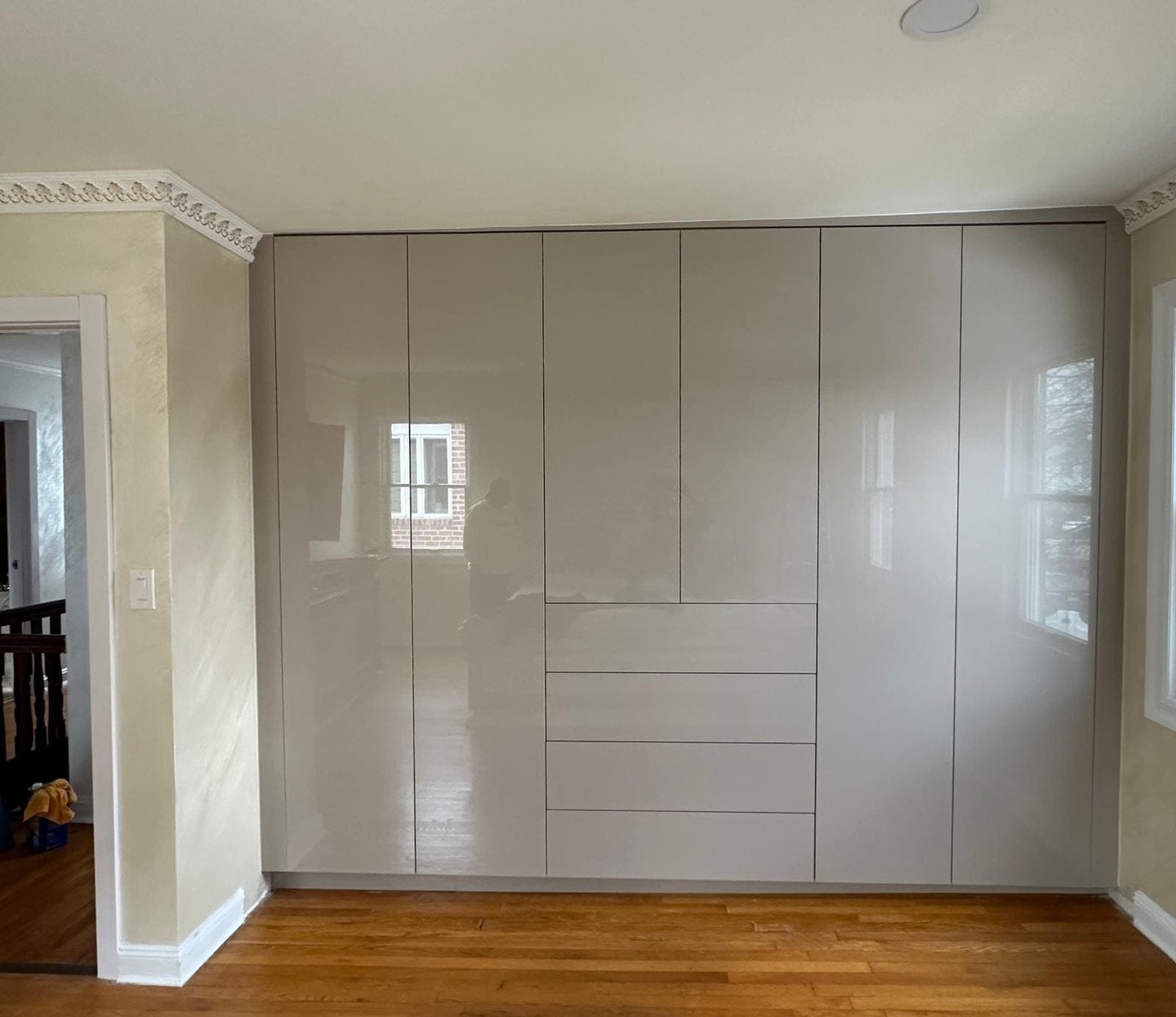 a room with a wooden floor and a white cupboard