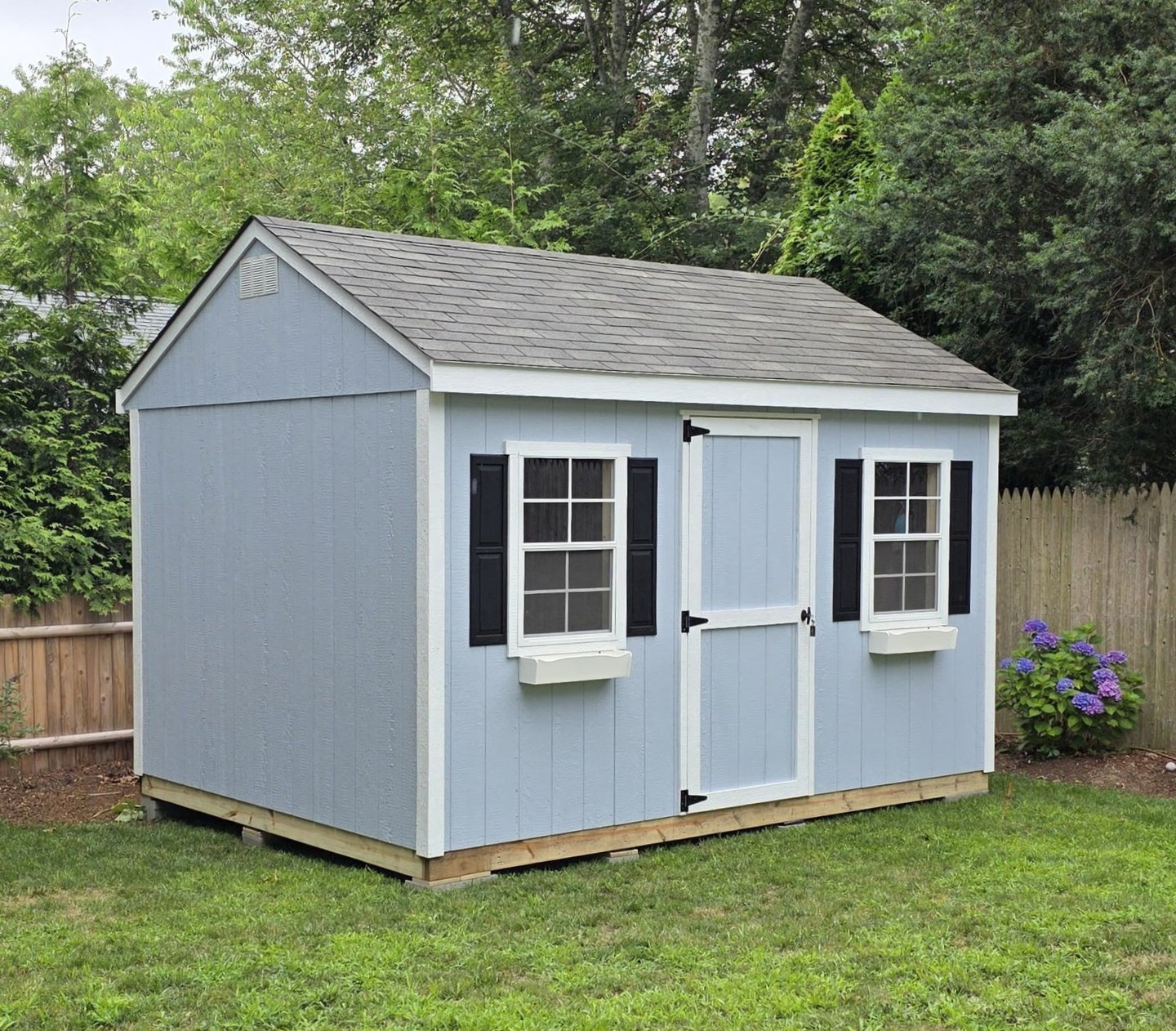 Custom painted backyard storage shed with LP SmartSide siding – professional shed painting option