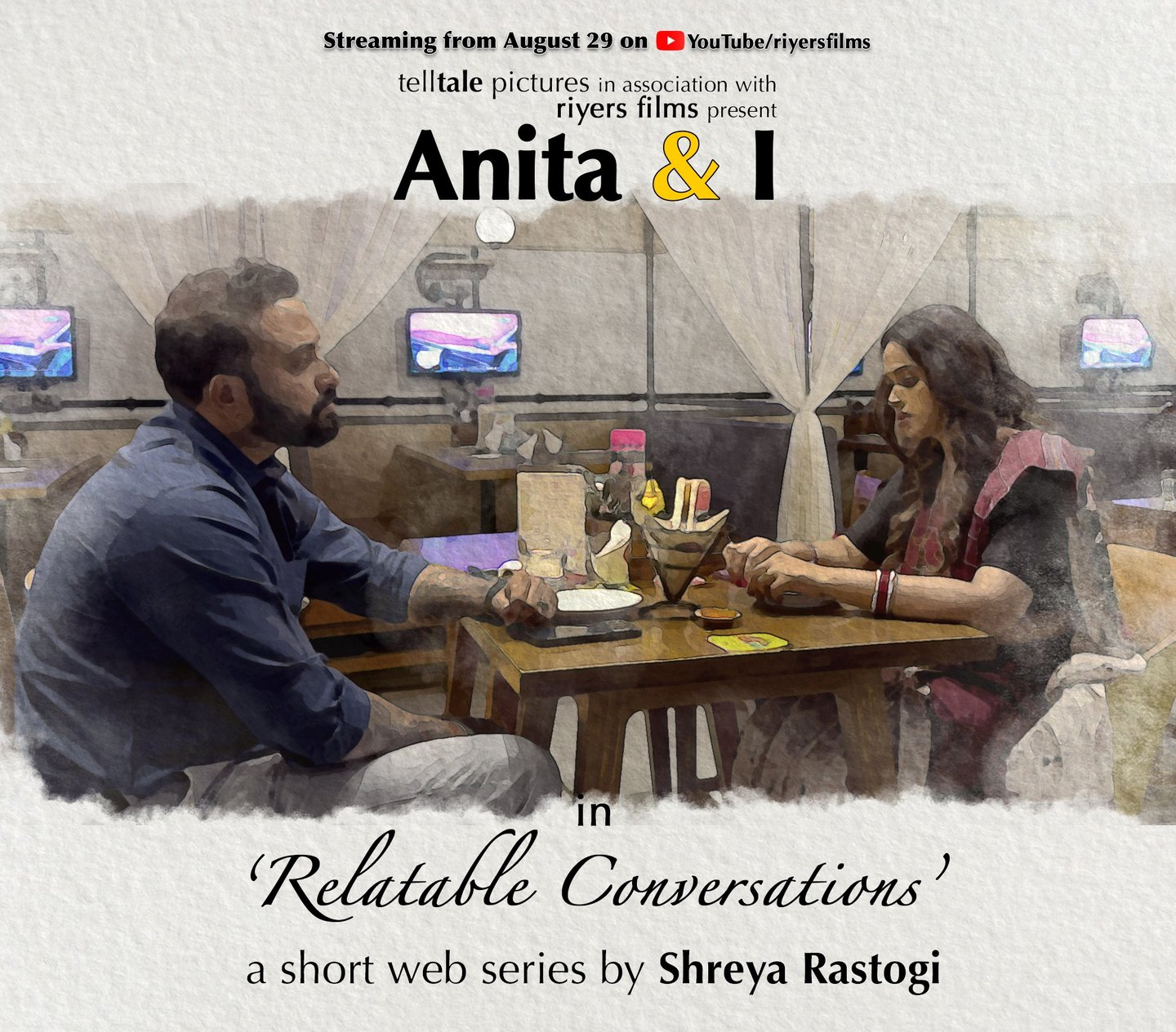 a man and woman sitting at a table with a man in a blue shirt