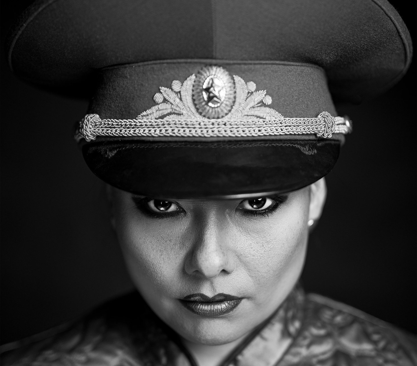 a woman in a military uniform with a hat on