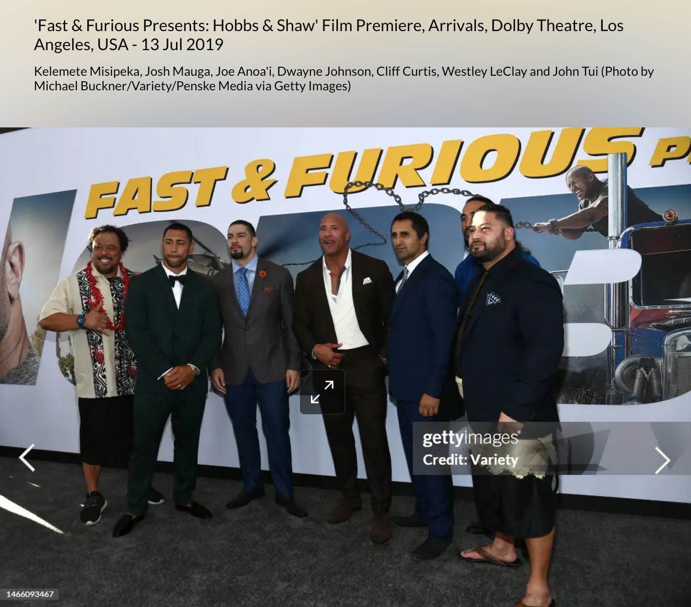 Dwayne Johnson with John Tui  in front of a fast & furious backdrop billboard 