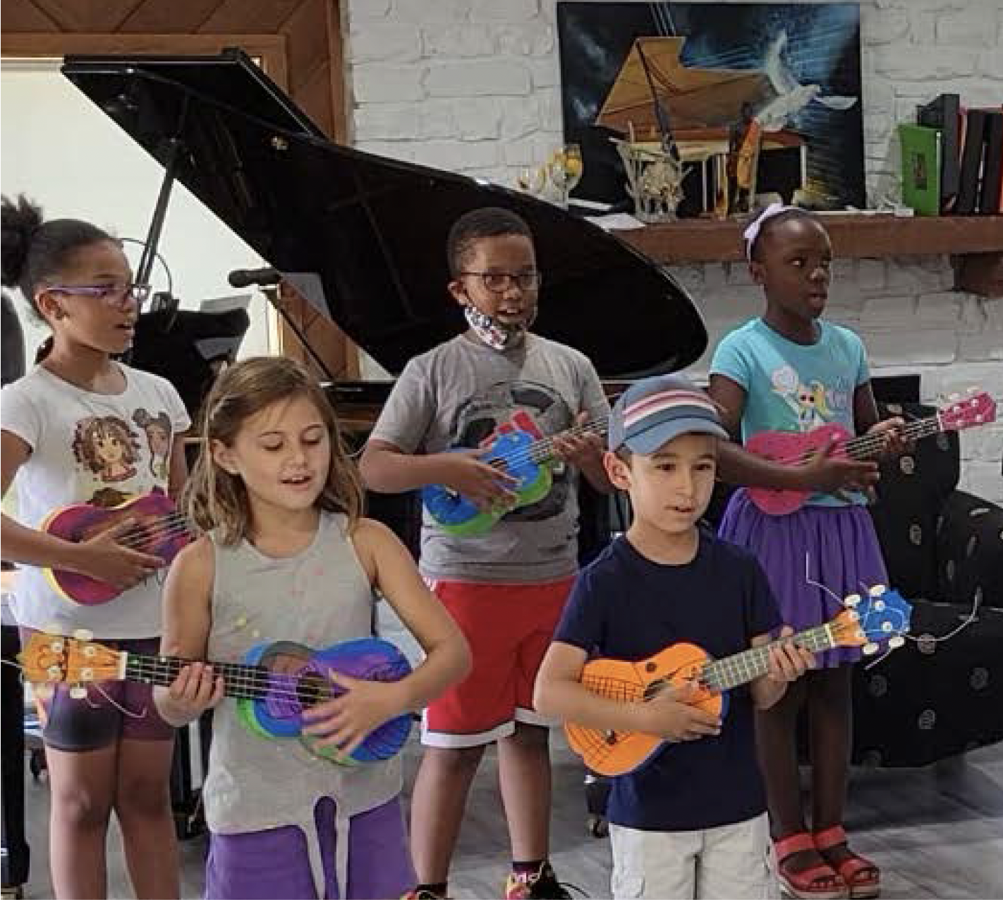 a group of children playing ukulele and singing