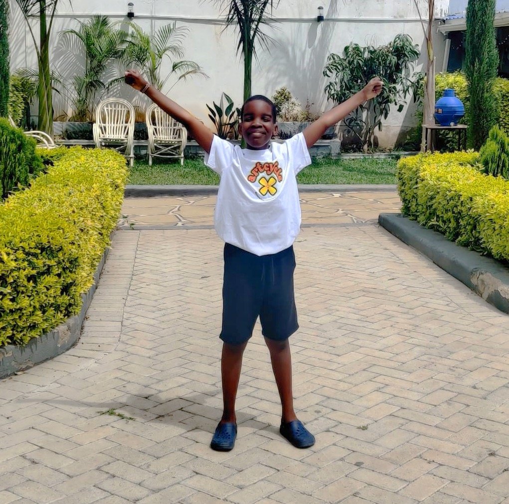 Little boy with arms in the air and smiling