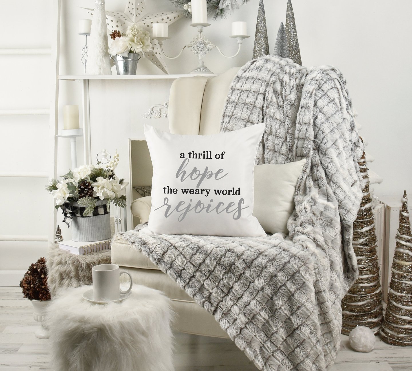 Cozy Christmas home with wing chair & fur throw. Coffee mug. Pillow reads "a thrill of hope the weary world rejoices."
