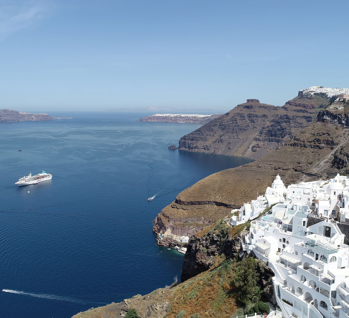White architecture and luxury resorts overlooking the Aegean Sea in Santorini, Greece.