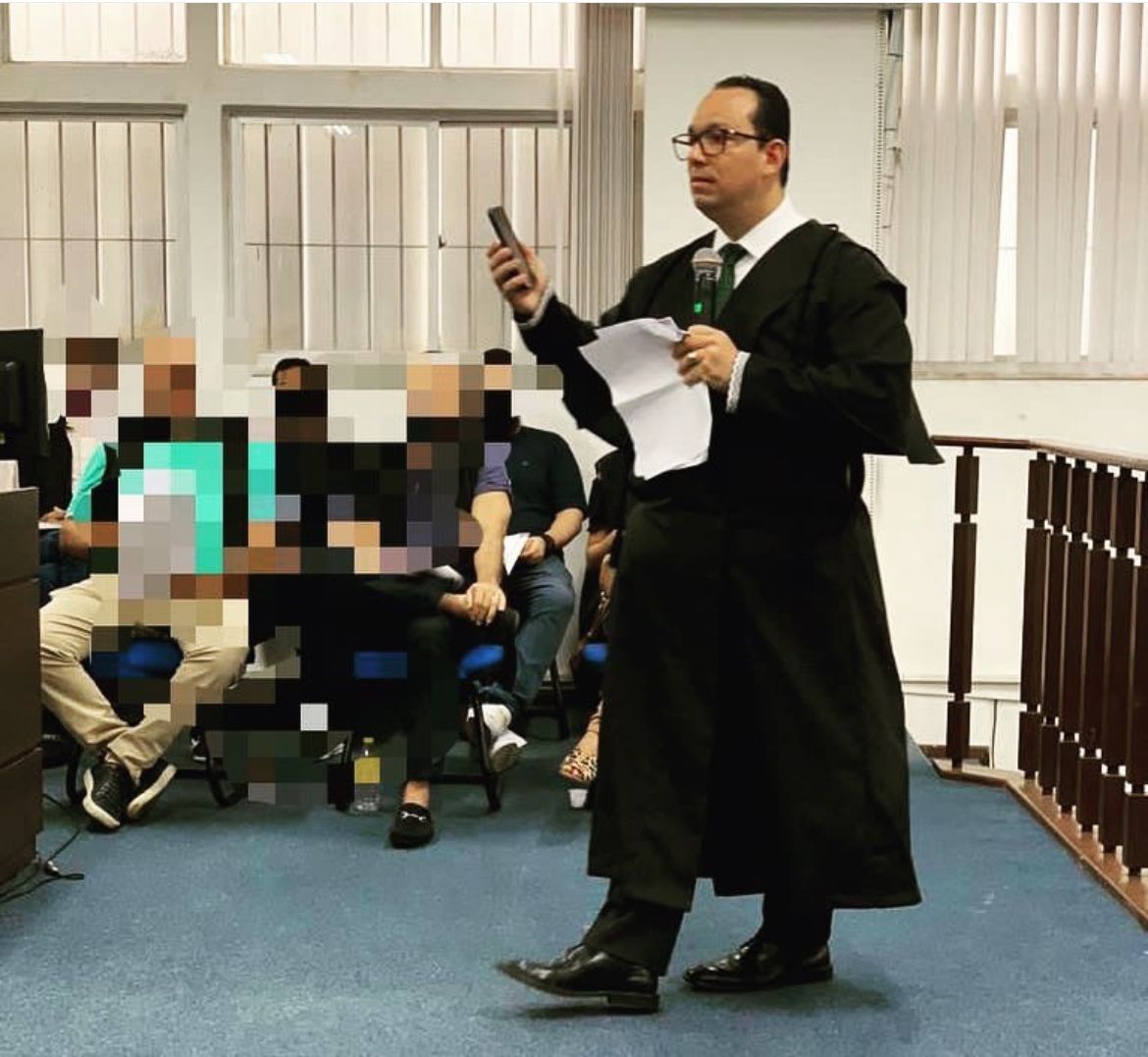 a man in a suit and tie is holding a cell phone