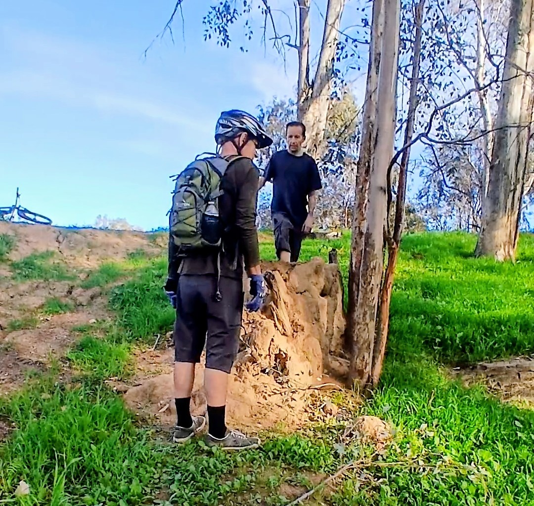Mountain biker standing wearing a hydration backpack