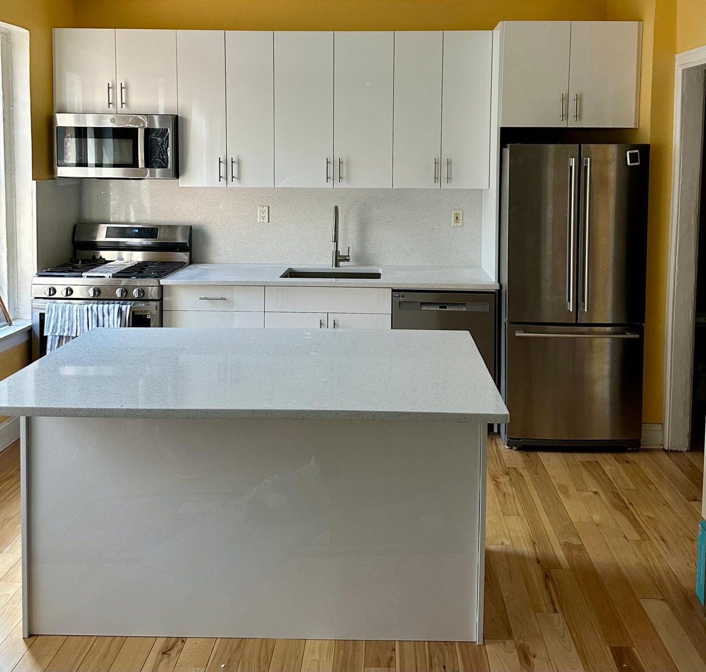 a kitchen with a stainless steel refrigerator and a refrigerator