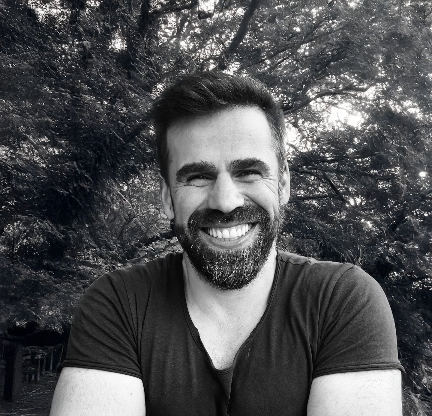 Adnan Erzen, Tai Ji and Qi Gong instructor at WDP Türkiye, smiling outdoors in a forest setting.