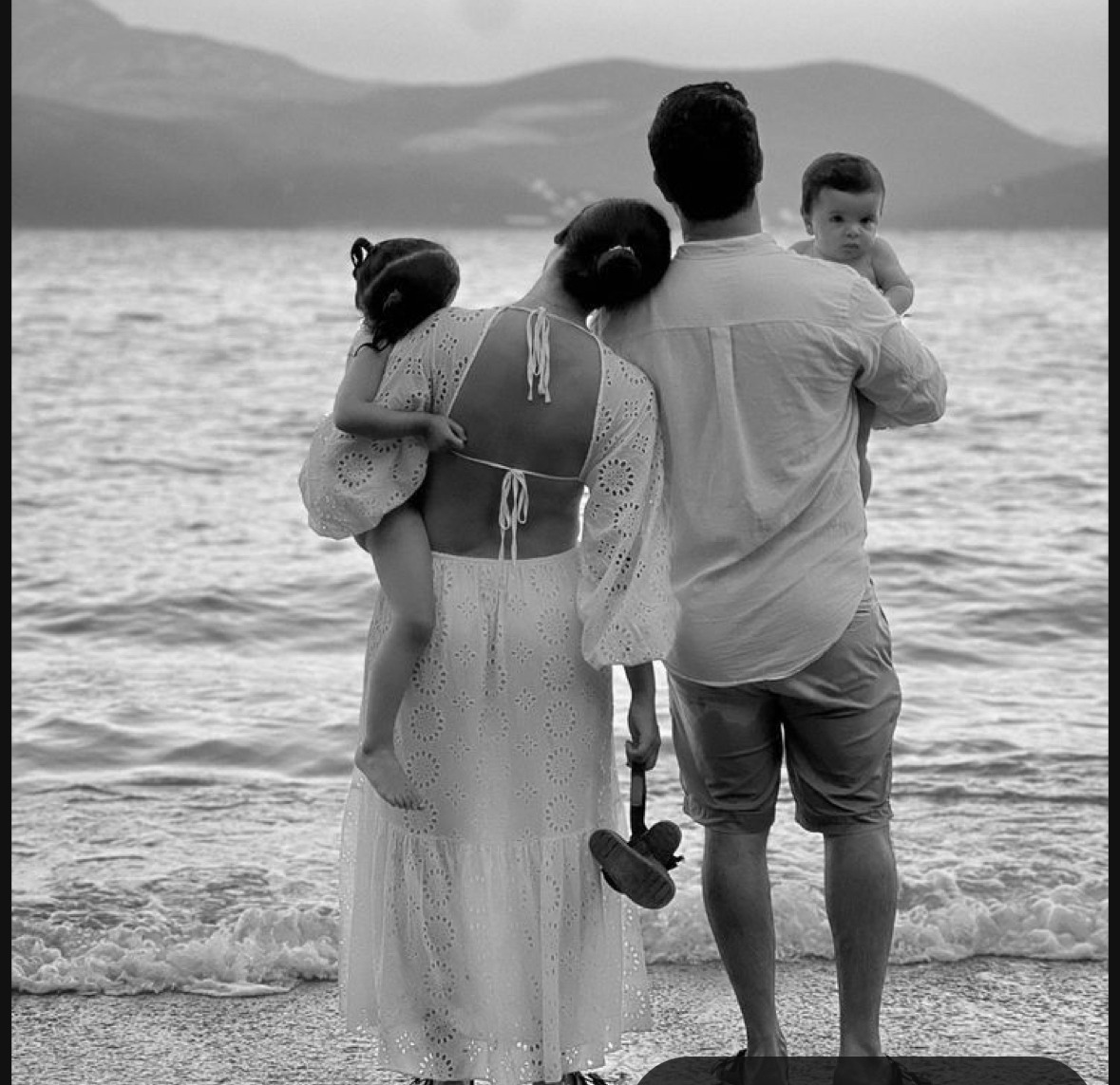 A couple doing couples therapy on the beach with their kids at hand