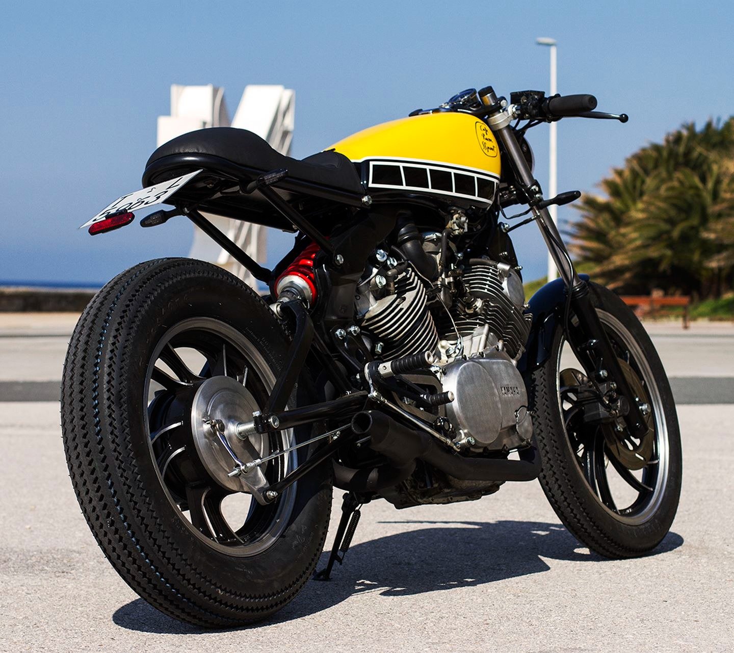 a motorcycle parked on the street in front of a building