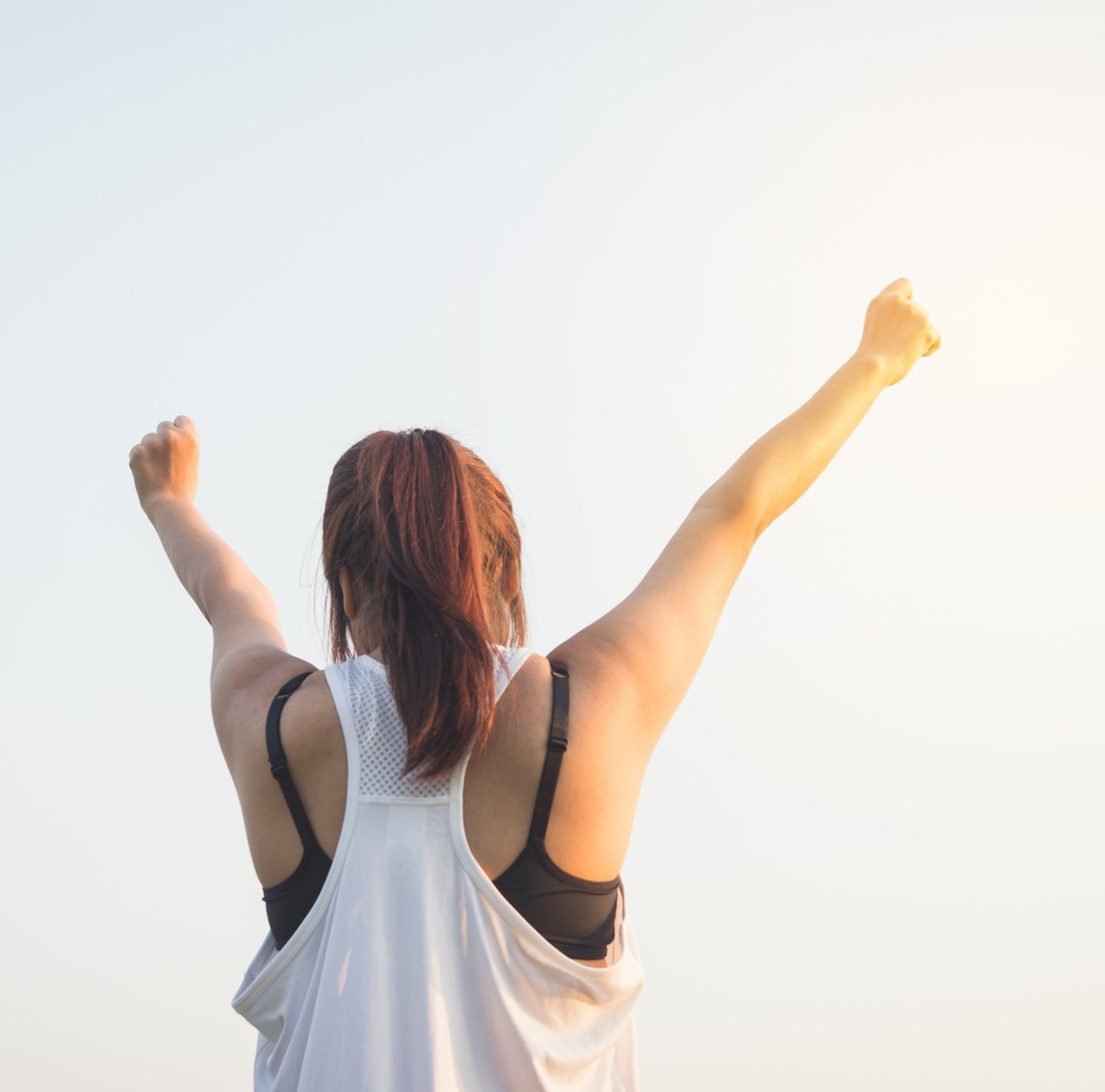 Eine Frau die ihre Arme in die Luft streckt