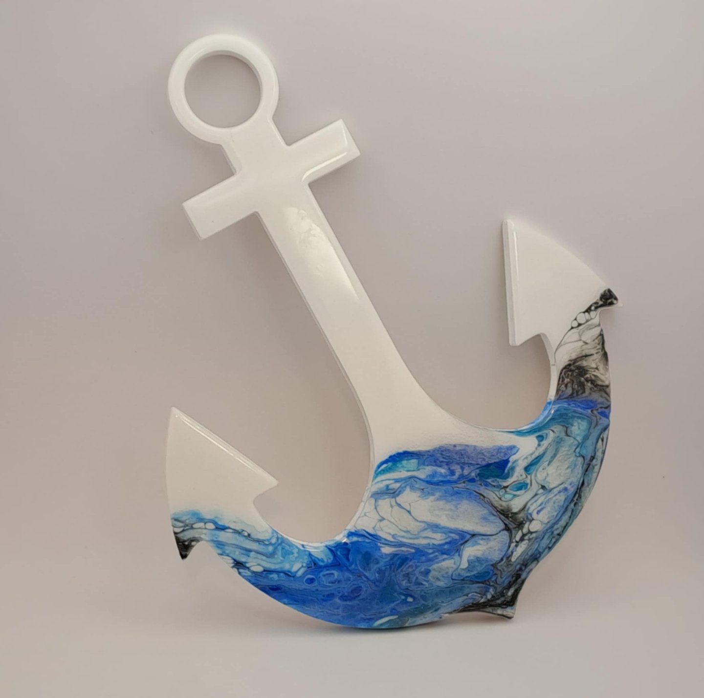 White nautical anchor wall decor with blue and white marble resin ocean wave art.