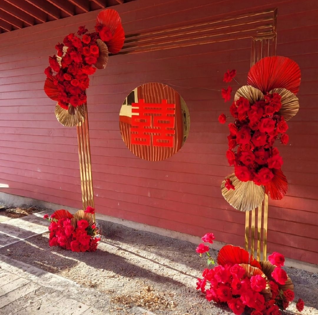 gold chrome backdrop with red roses and a double happiness sign for rent