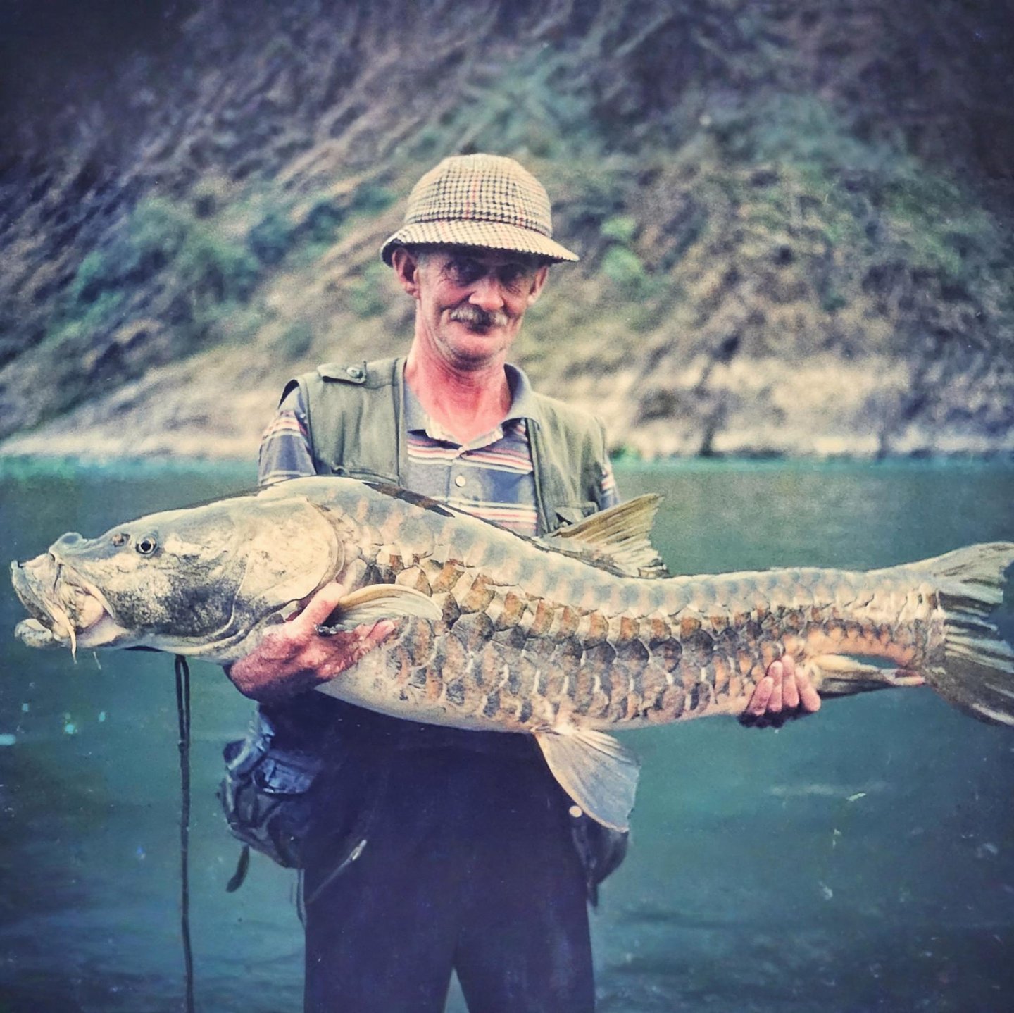 Legendary angler Christopher Oldmeadow holding a Golden Mahseer.