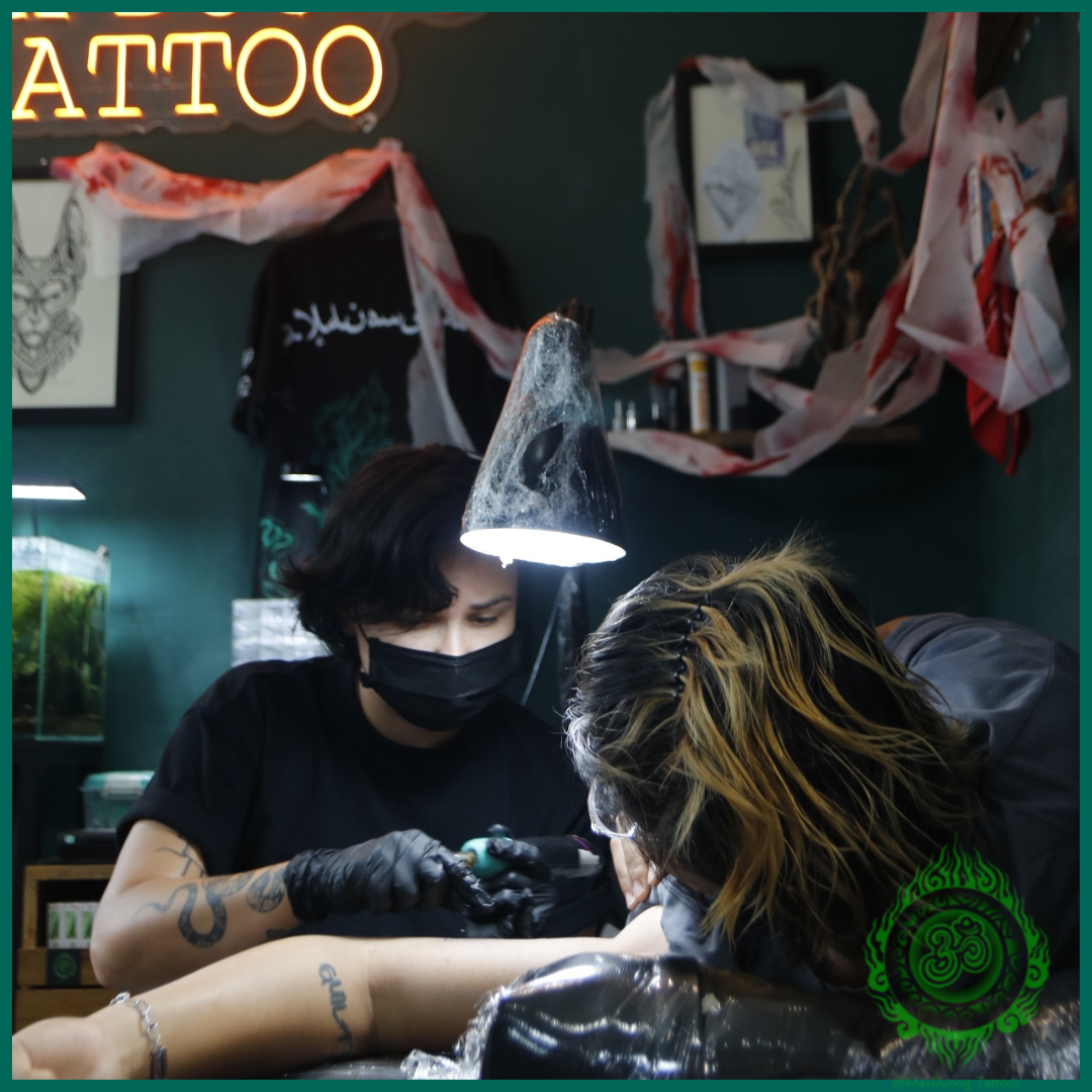 tattoo artist are tattooing