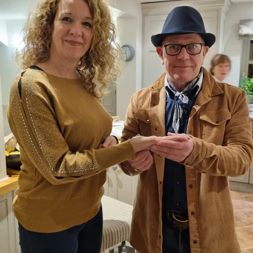 Rob hamilton reading the palm of one of his clients