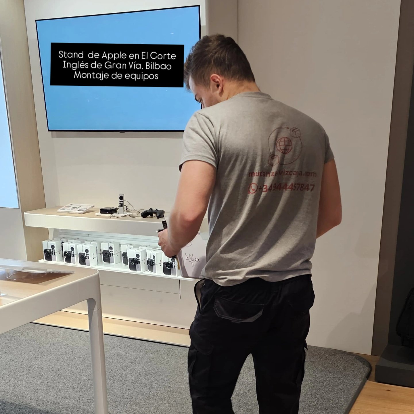 a man standing in front of a large screen