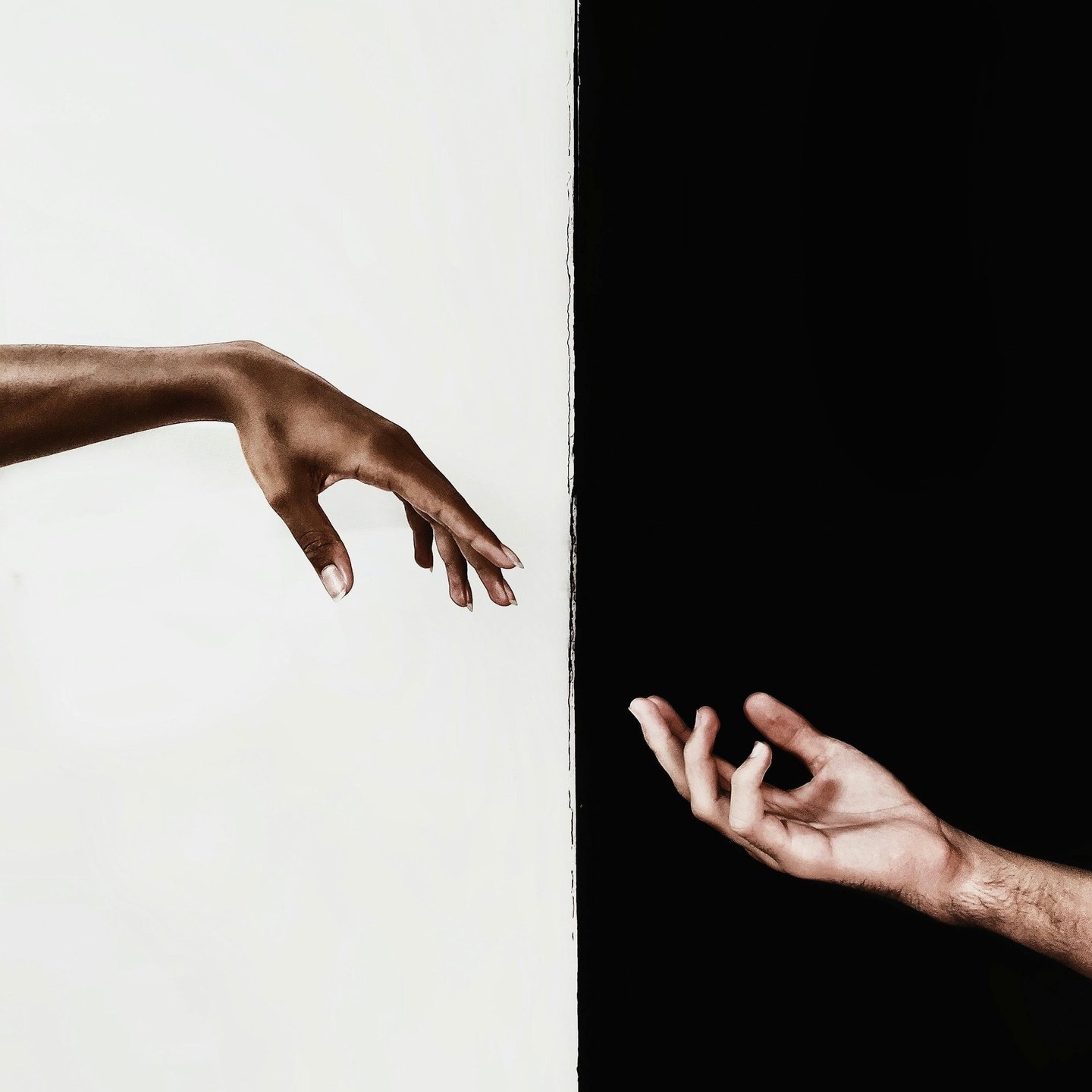 two hands reaching out to each other from opposite directions