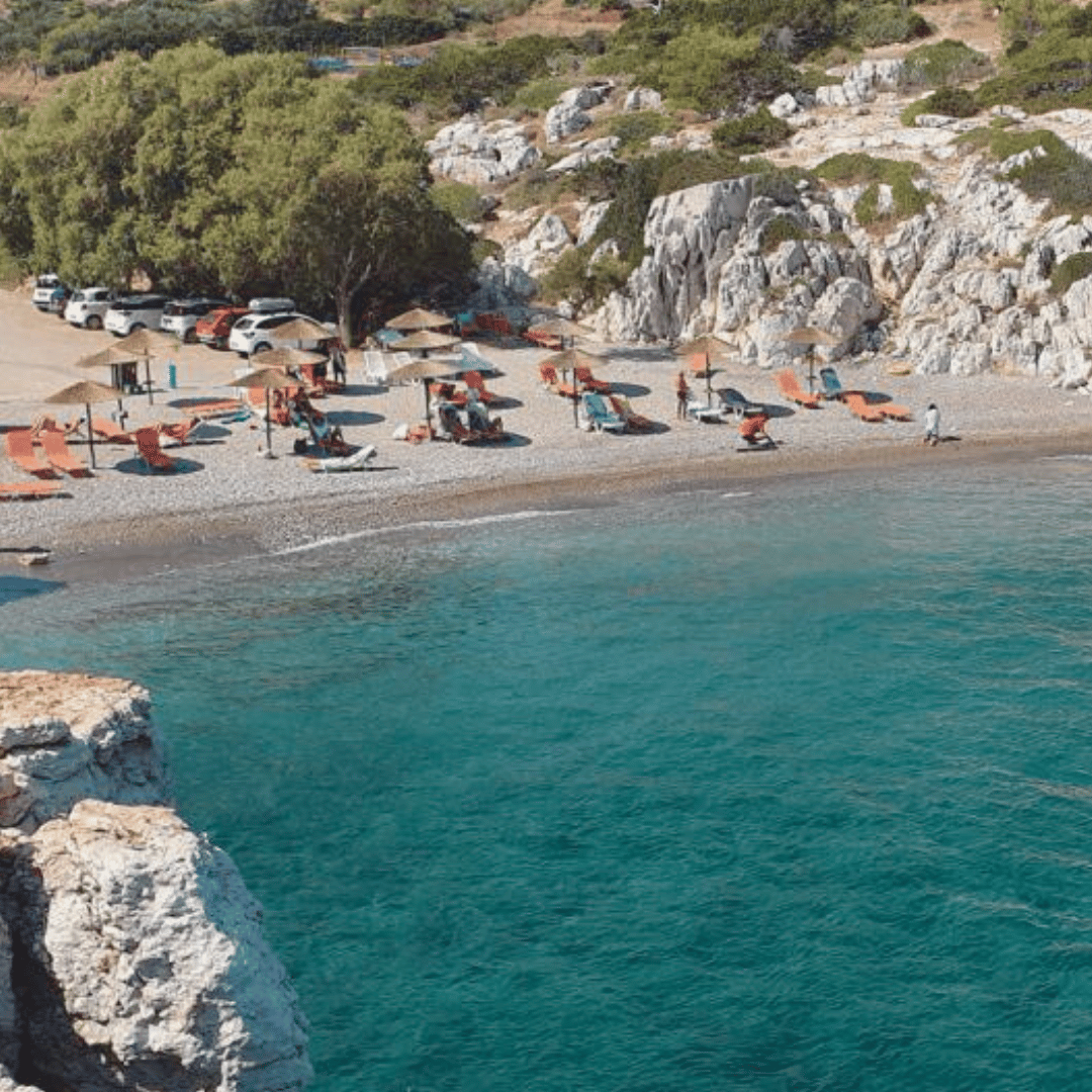 a beach with many chairs and umbrellas