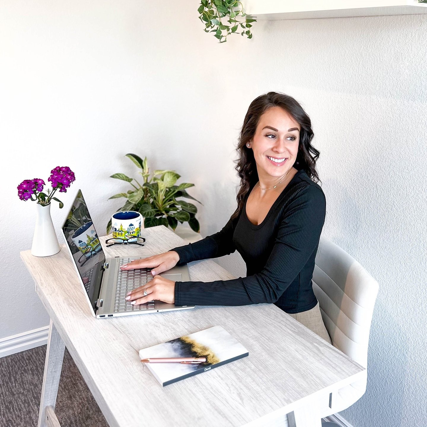 Professional writer at writing at a desk and smiling