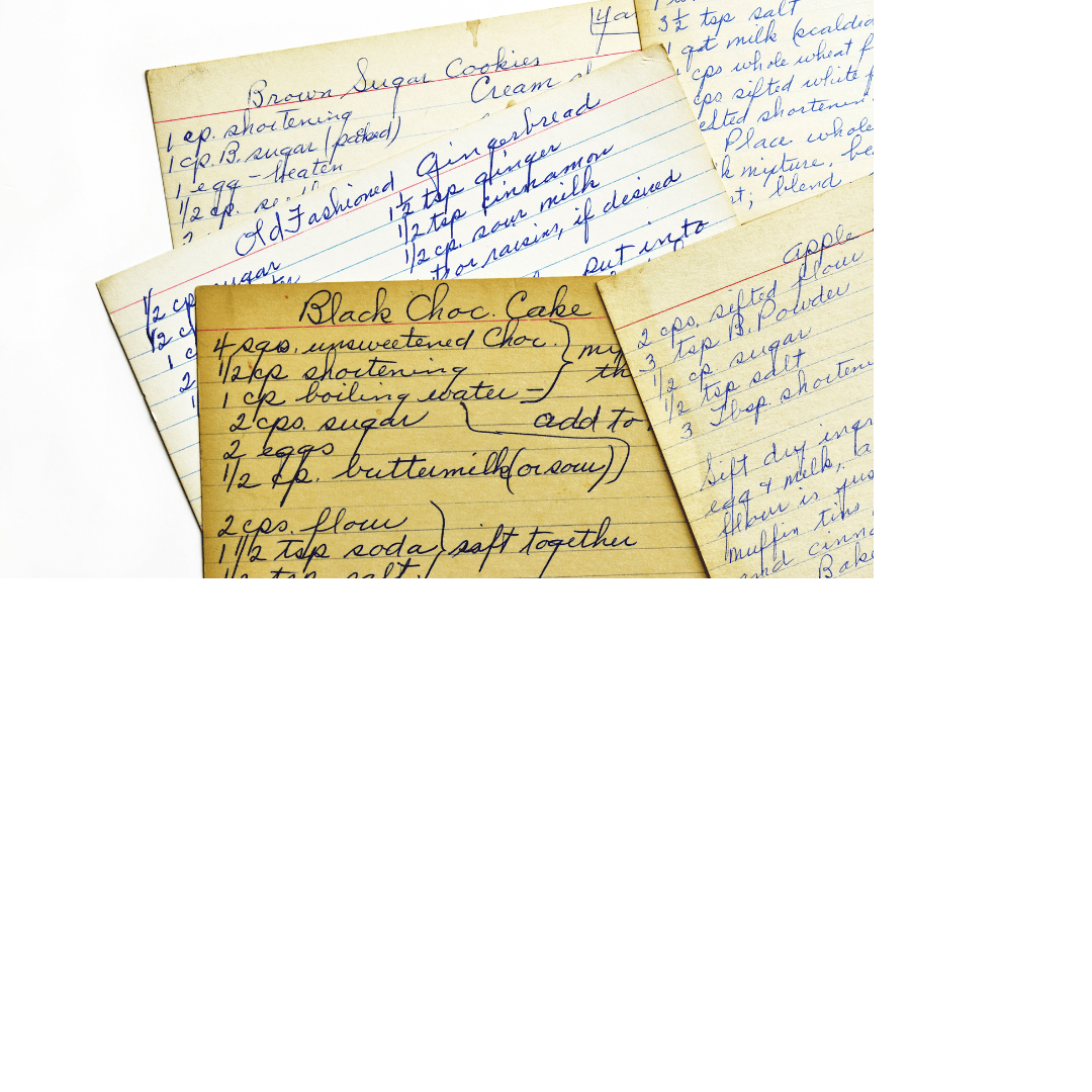 Photo of several yellowed recipe cards with handwritten recipes on them