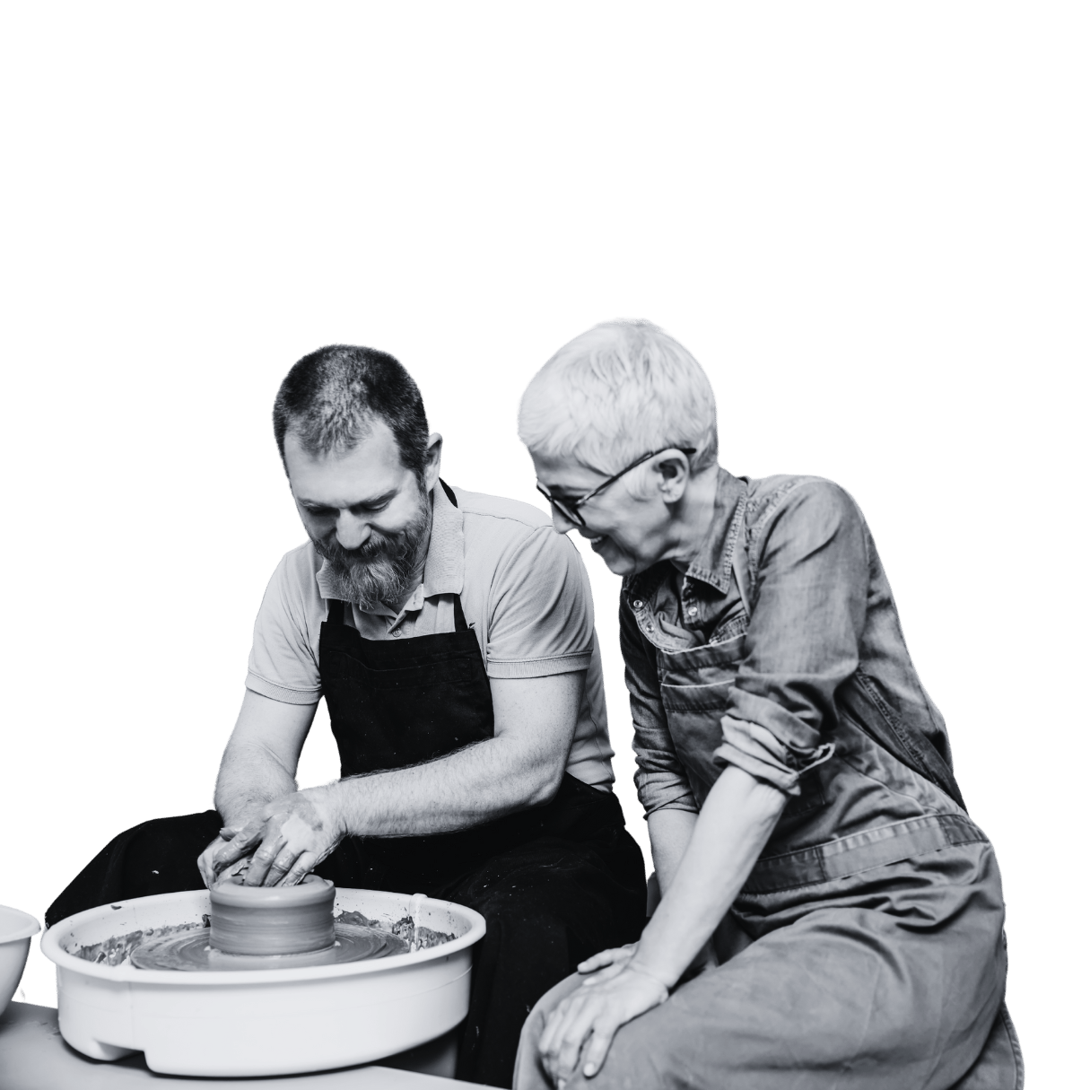 A man and woman using a pottery wheel