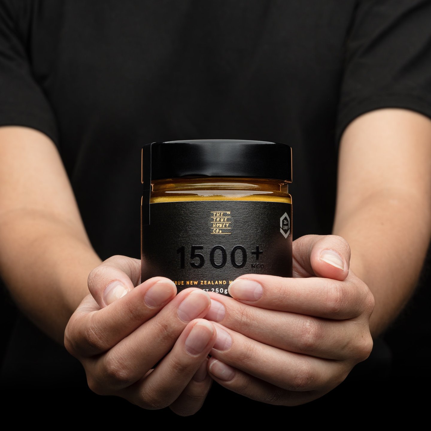 Product photography - a person holding a jar of honey