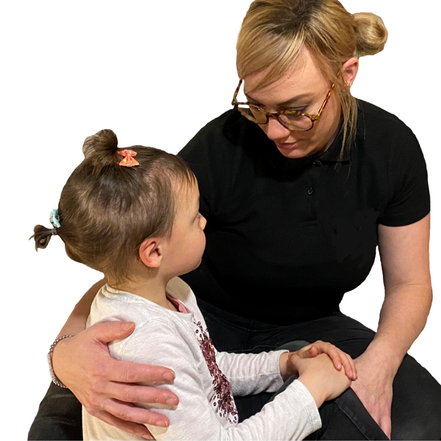 A first aider with her arm around a small child comforting them