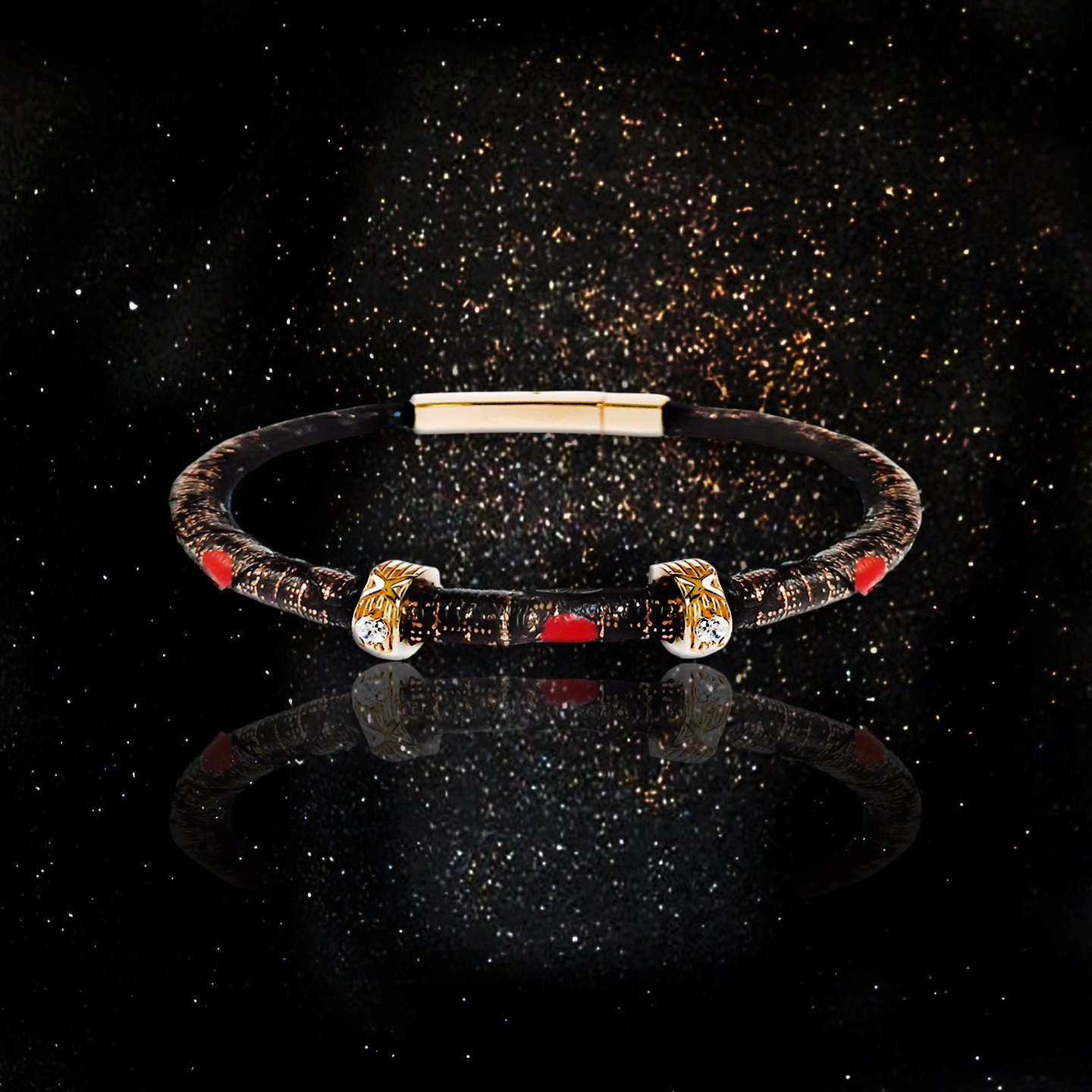 Luxury designer bangle bracelet with gold accents and red details on a black glitter background.