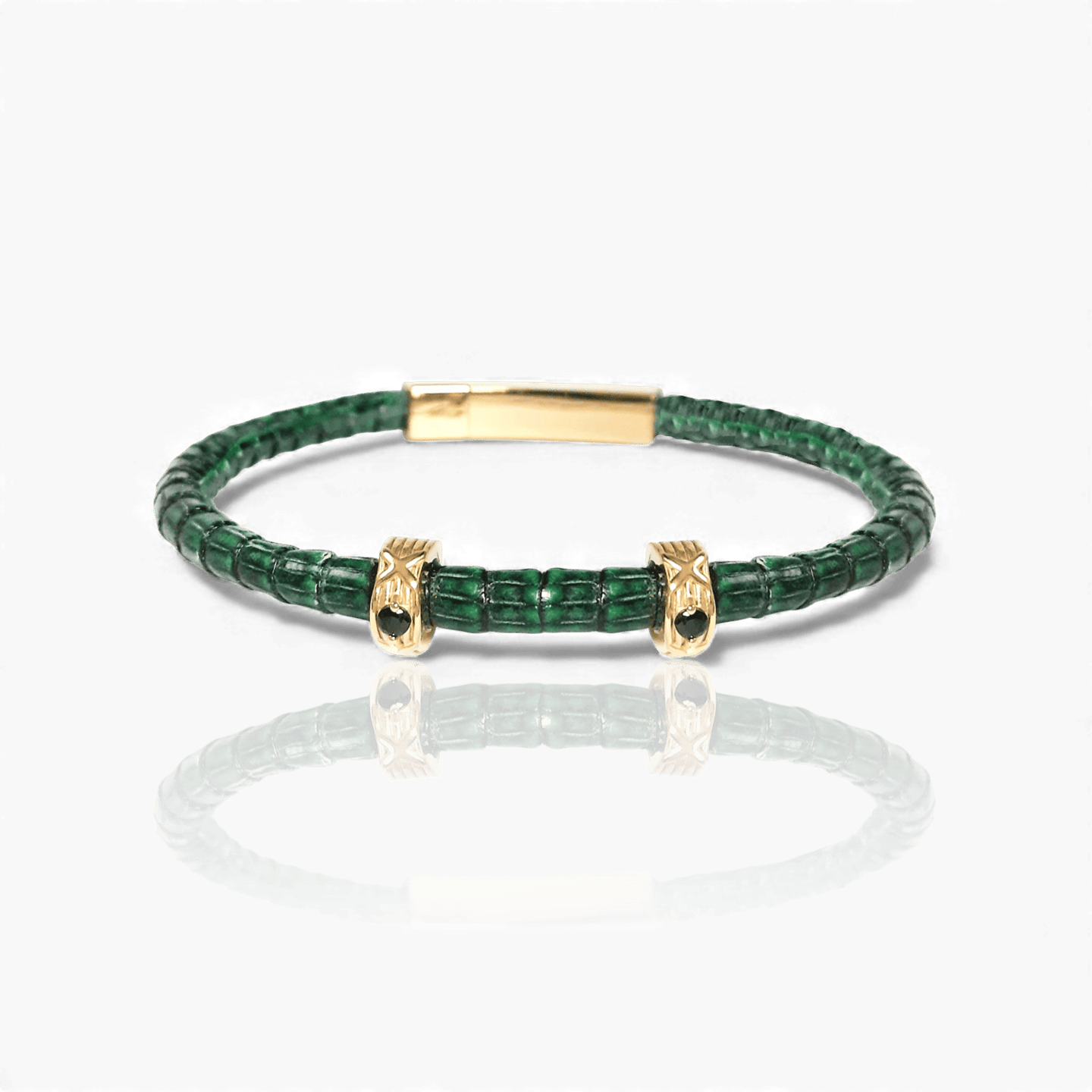 Luxury green crocodile leather bracelet featuring gold accents and black crystals.s.